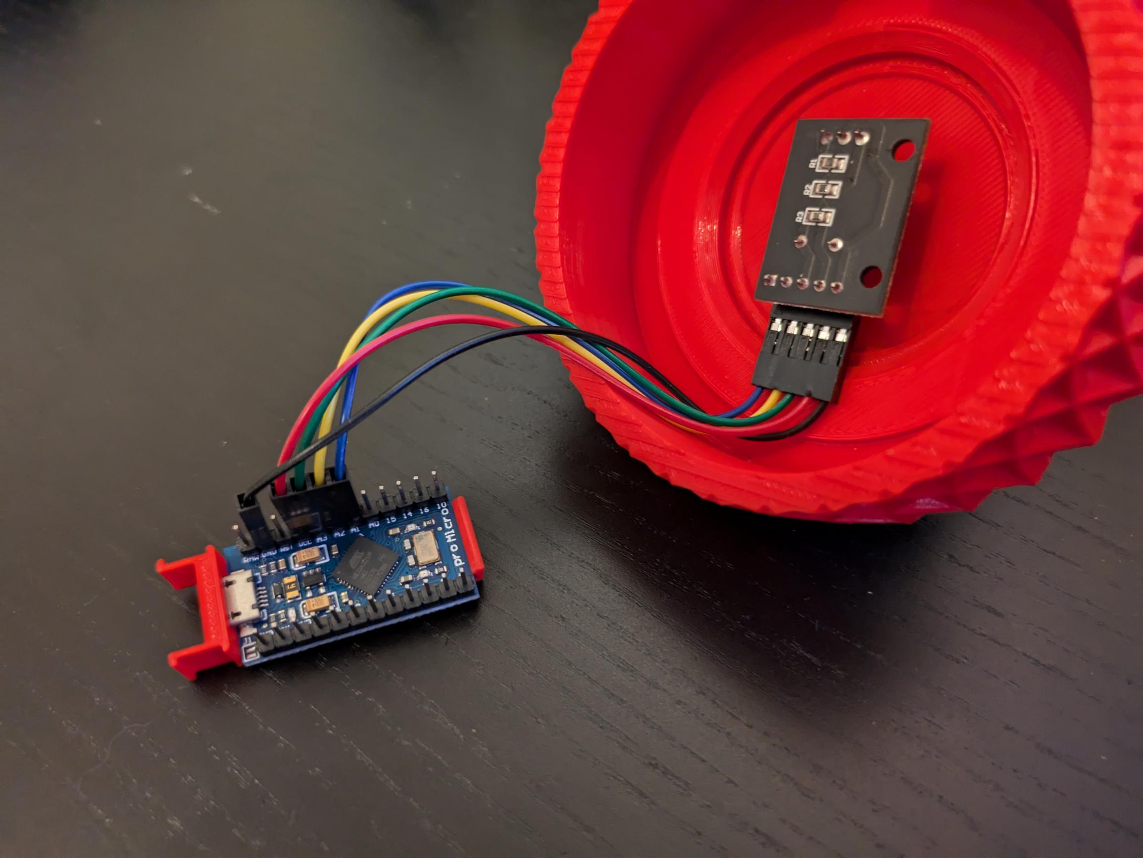 Photo of the knob on it's side with the Arduino holder separate